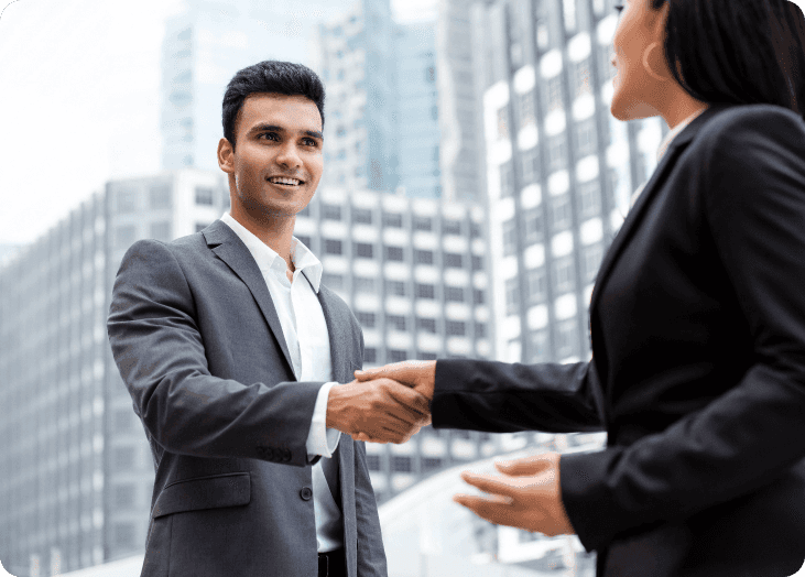 A male employee shaking hands with a female employee