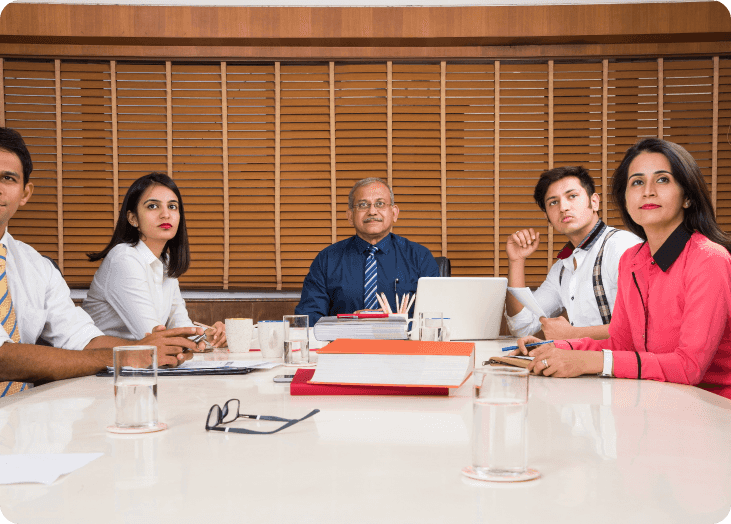Image of our sponsors sitting at a table, engaged in a discussion
