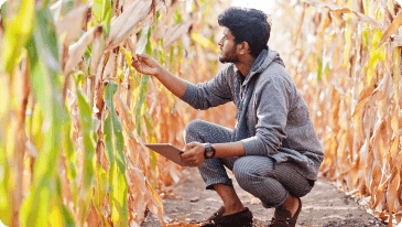 Image of a Farm enterpreneur proudly showcasing his agricultural work